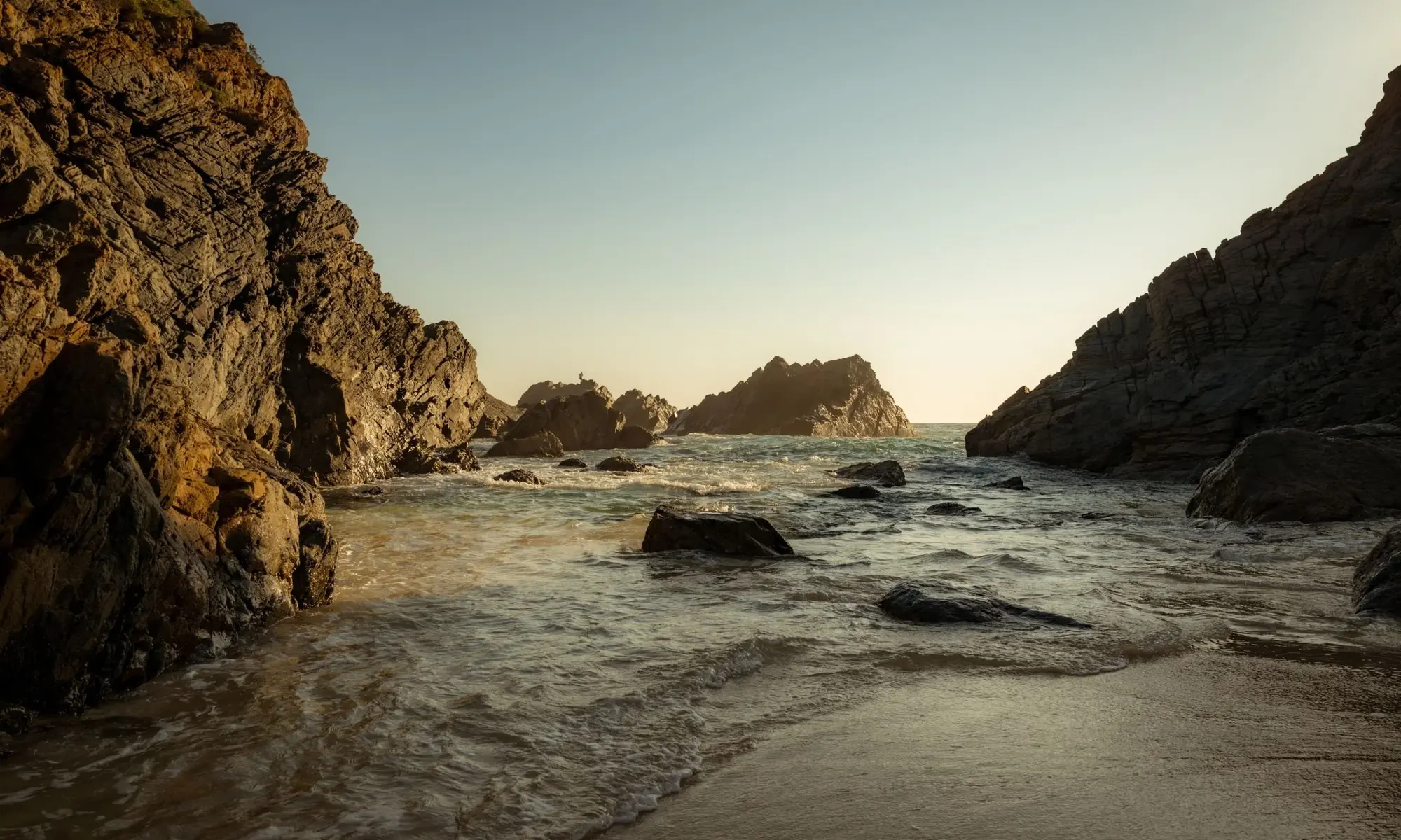 A quiet rocky cove at sunset