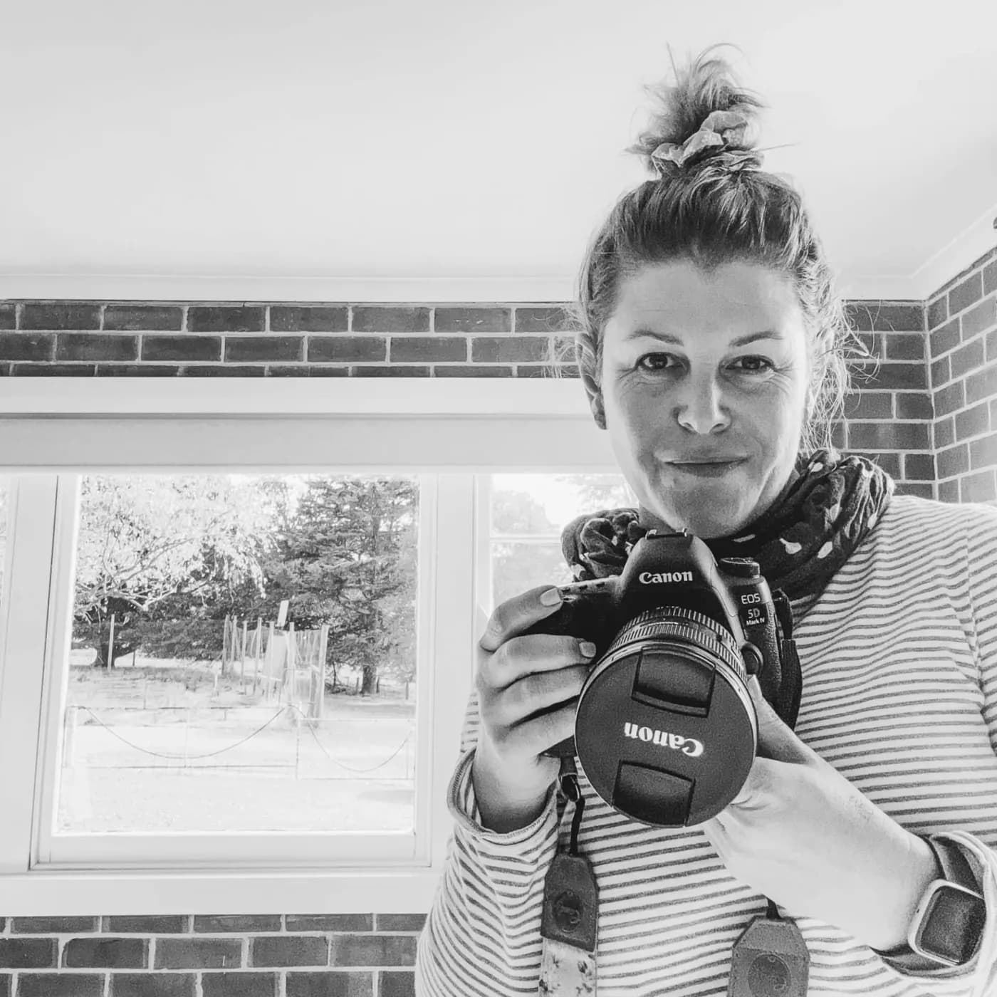 Fee May of Hamlet & Fields, MISO Studio's brand photography and social media partner, holding a camera